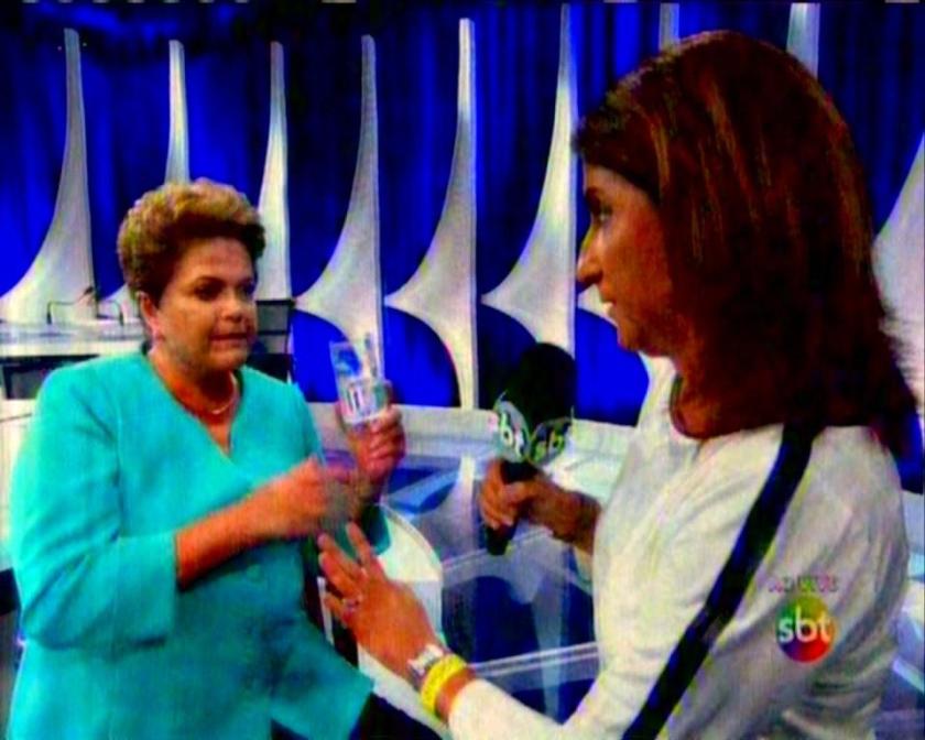 Dilma sofre queda de pressão arterial e é amparada pela própria repórter do SBT. Aécio achou bom.